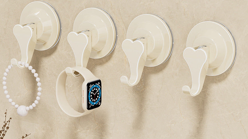 Four white suction cup hooks on a beige wall with text indicating ABS material and installation features.